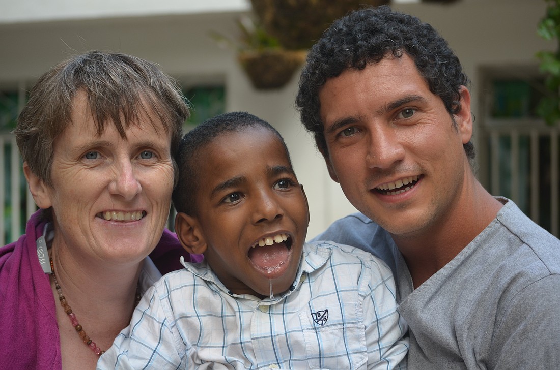 Gena Heraty, a longtime Irish missionary in Haiti, is pictured with a special needs child and another young man, in a 2014 photo. Heraty was among several people -- including a three-year-old child -- taken in the early hours of Aug. 3, 2025, after gunmen breached the Saint-Hélène orphanage in Kenscoff, near Haiti's capital of Port-au-Prince. (OSV News photo/courtesy NPH International)