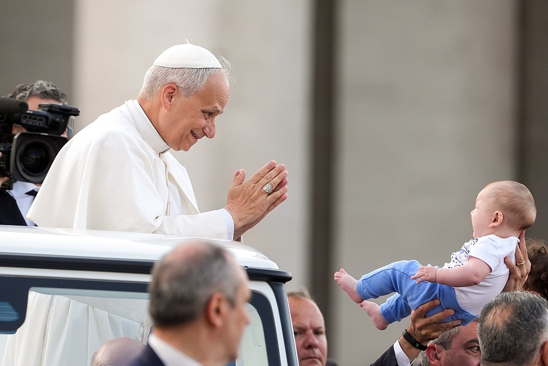 Pope Leo XIV greets a child from the popemobile as he prepares to lead a Pentecost prayer vigil in St. Peter's Square at the Vatican June 7, 2025, with participants in the Jubilee of Ecclesial Movements, Associations and New Communities. (CNS photo/Lola Gomez)
