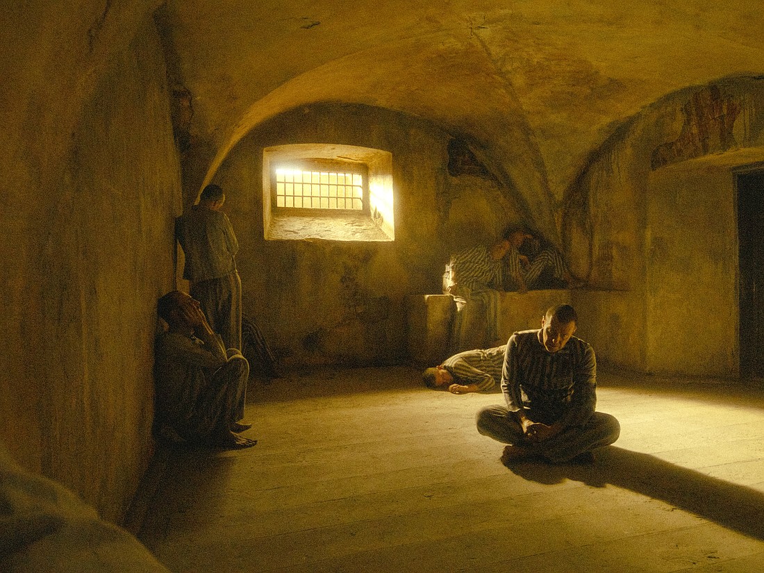 Polish actor Marcin Kwasny portrays Polish Conventual Franciscan Father Maximilian Kolbe in the death starvation cell at the Nazis' main Auschwitz concentration camp, where he died Aug. 14, 1941. The priest's last moments are the core story of a new movie about him titled "Triumph of the Heart" by American filmmaker Anthony D'Ambrosio, which premiered Aug. 13, 2025, in Poland and is set to arrive in U.S. theaters Sept. 12. Father Kolbe was canonized in 1982. (OSV News photo/courtesy Rafael Film)