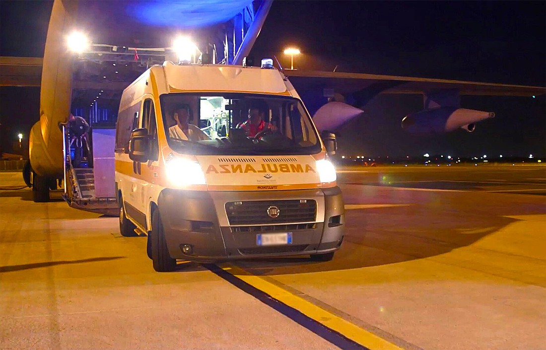 An ambulance pulls up to an Italian military plane at Rome's Ciampino airport late Aug. 13 to transfer children from Gaza to the Vatican-owned Bambino Gesù pediatric hospital for treatment. (CNS photo/courtesy Bambino Gesù hospital)