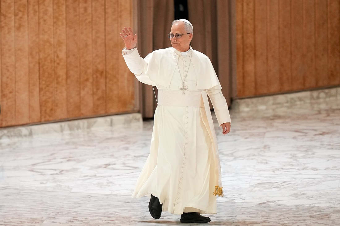 Pope Leo XIV greets visitors and pilgrims as he arrives in the Paul VI Audience Hall at the Vatican for his weekly general audience Aug. 13, 2025. (CNS photo/Lola Gomez)
