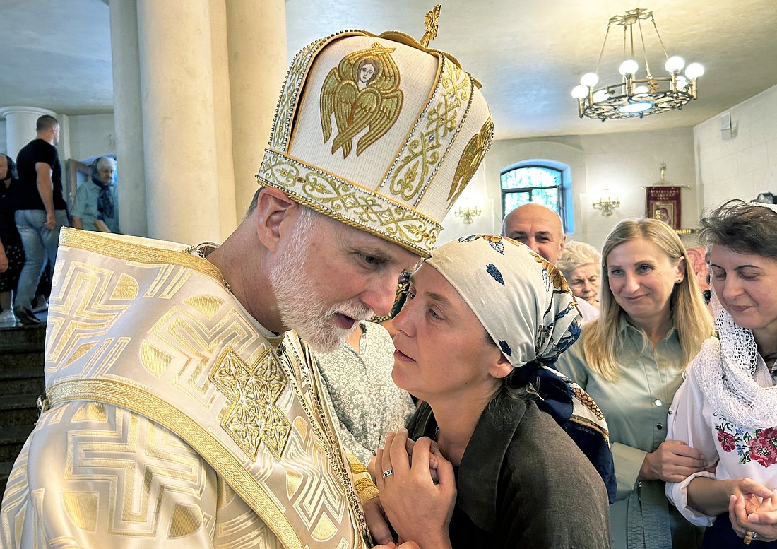 A woman speaks with Metropolitan Archbishop A. Gudziak of the Ukrainian Greek Catholic Archeparchy of Philadelphia Sept. 8, 2024, following Divine Liturgy at St. Nicholas the Wonderworker Ukrainian Greek Catholic Church in Kharkiv, Ukraine. Archbishop Gudziak said the Alaska summit between U.S. President Donald Trump and Russian President Vladimir Putin held on Aug. 15, 2025, has ultimately failed to address the "fundamental moral and geopolitical questions" of Russia's multiyear war on Ukraine. (OSV News photo/Gina Christian)