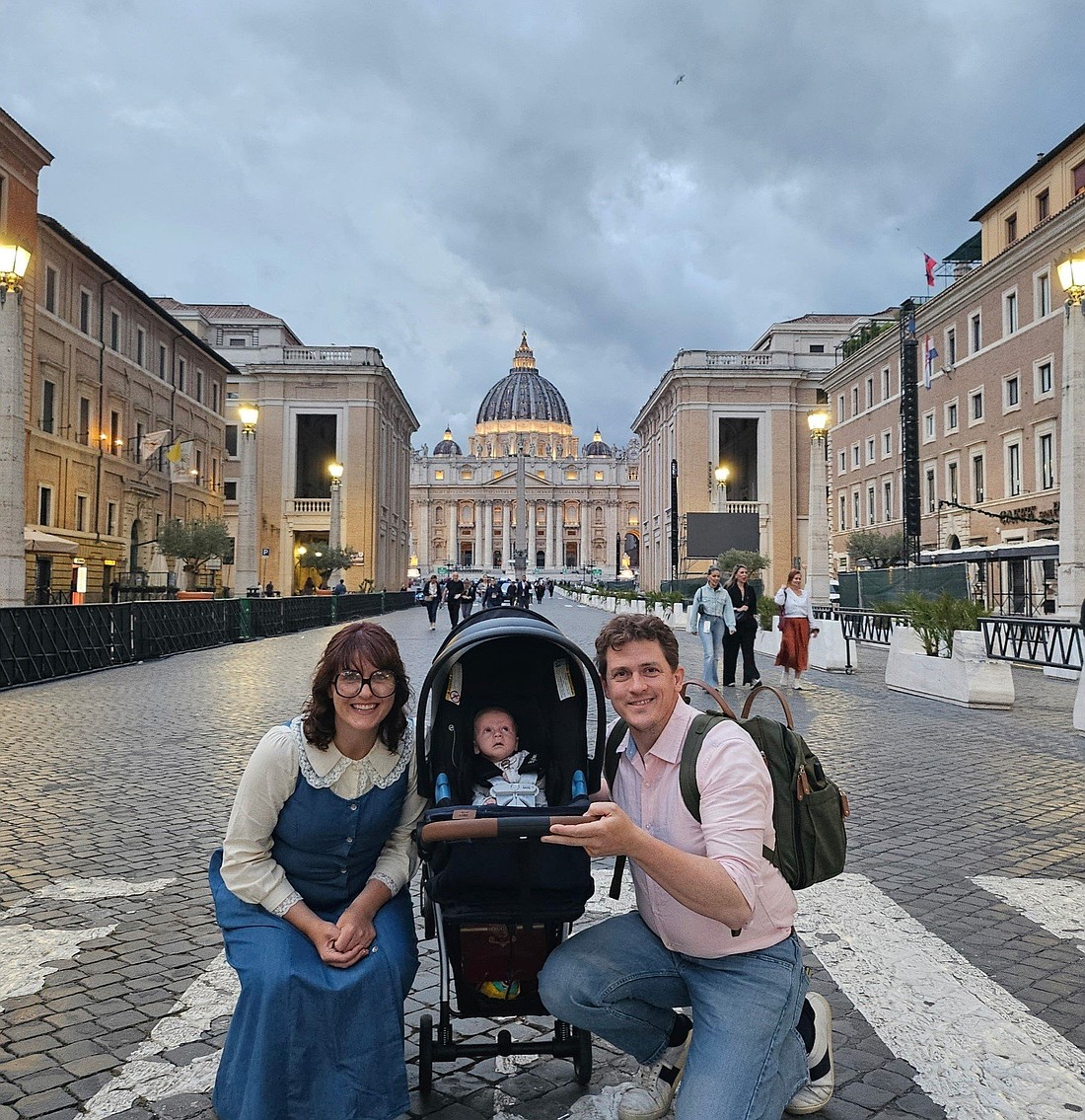 With St. Peter’s Basilica in the background, Arielle and Brandon Brown of Sts. Peter and Paul Cathedral  in Indianapolis, pose for a photo with their child, Laurence, during a trip to Rome in May 2025. Pope Leo XIV blessed the child during his first general audience at the Vatican May 21, 2025. (OSV News photo/courtesy Brown family)