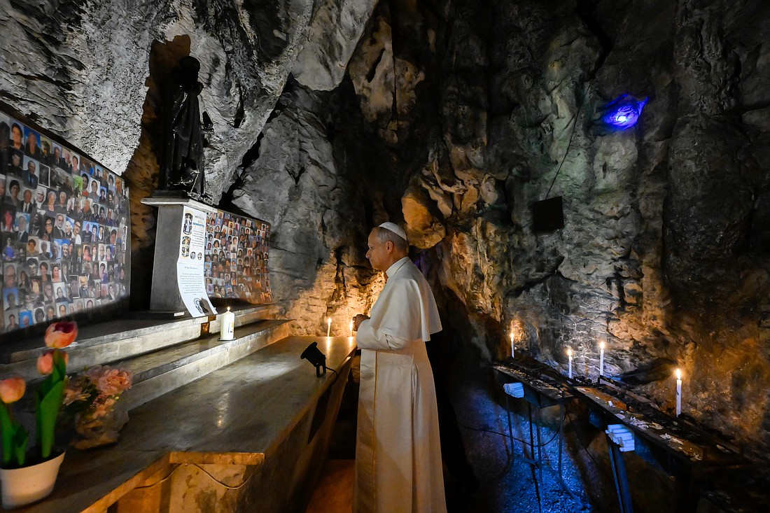 Pope Leo XIV lights a candle and prays in the Cave of St. Benedict at the Shrine of Our Lady of Grace of Mentorella near Guadagnolo, Italy, Aug. 19, 2025. Tradition holds that St. Benedict lived in the cave as a hermit for two years during his early monastic life. (CNS photo/Vatican Media)