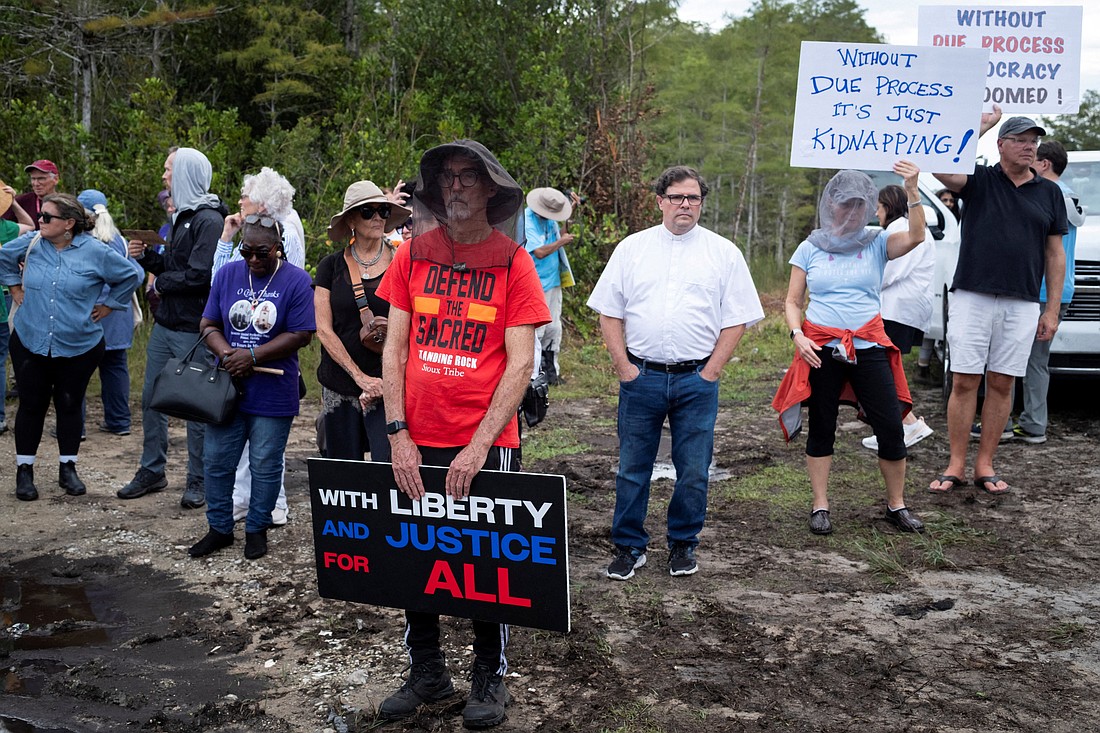 People attend a vigil in support of immigration detainees at the entrance of "Alligator Alcatraz" Immigration and Customs Enforcement, ICE, detention center at the Dade-Collier Training and Transition Airport in Ochopee, Fla., Aug. 10, 2025. ICE detentions at "Alligator Alcatraz" are splitting up vulnerable families, nonprofit says; the facility faces two court challenges, while ICE plans a second Florida facility dubbed "Deportation Depot" and one in Indiana being called "Speedway Slammer." (OSV New/Marco Bello, Reuters)