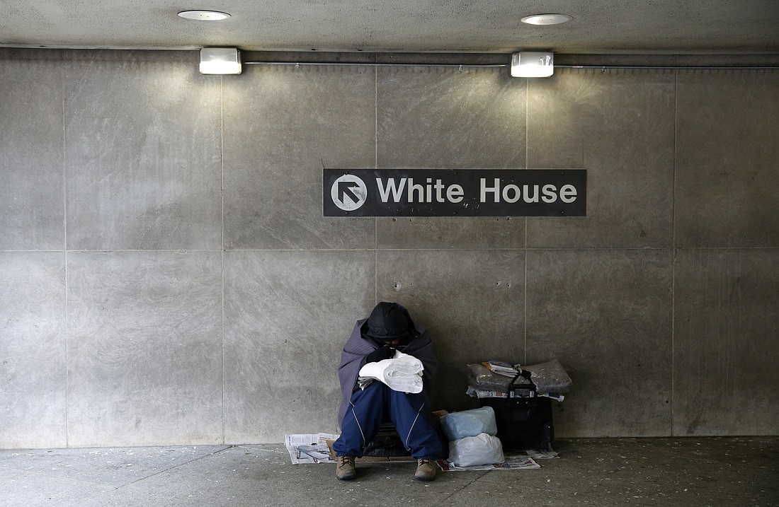 A file photo shows a homeless person trying to stay warm at the entrance of a Metro station near the White House in Washington. On Aug. 11, 2025, President Donald Trump announced he was placing the District of Columbia police "under direct federal control," activating the National Guard and getting rid of homeless encampments in an effort to combat crime in the district. (OSV News photo/Kevin Lamarque, Reuters)