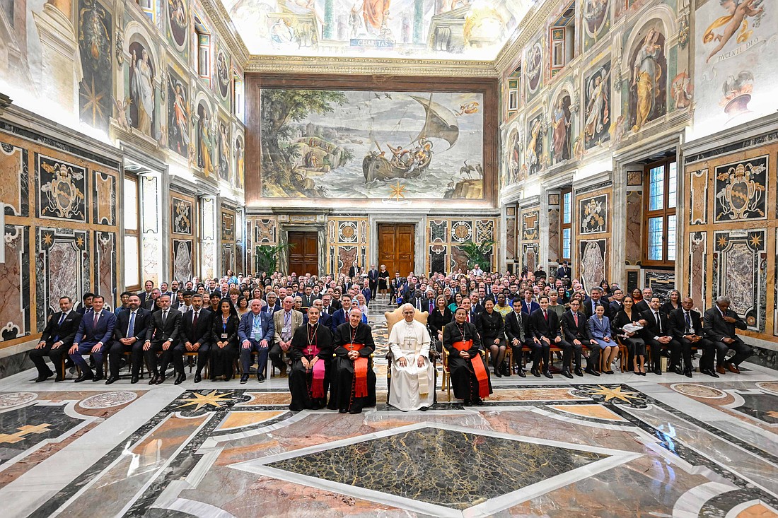Pope Leo XIV poses for a photo with members of the International Catholic Legislators Network Jubilee pilgrimage in the Clementine Hall of the Vatican Apostolic Palace Aug. 23, 2025. The pope is seated between Austrian Cardinal Christoph Schonborn, retired archbishop of Vienna, left, and Cardinal Charles Maung Bo of Yangon, Myanmar, who are honorary patrons of the network. (CNS photo/Vatican Media)