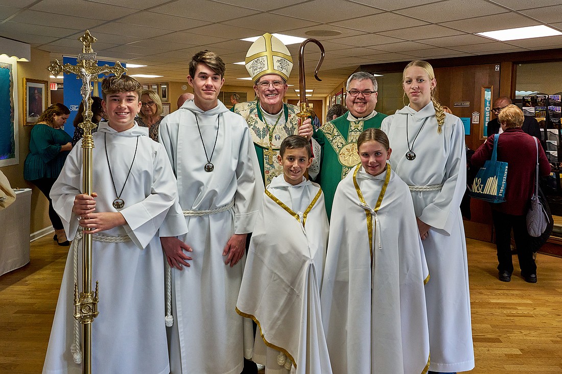 Bishop David M. O’Connell, C.M., and Father Michael A. Santangelo, pastor, join altar servers of Epiphany Parish, Brick, following the parish’s 50th anniversary closing Mass, November 2024. Vic Mistretta photo