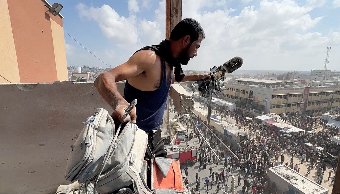 A man holds the equipment used by Palestinian cameraman Hussam al-Masri, who was a contractor for Reuters, at the site where he was killed along with other journalists and people in Israeli strikes on Aug. 25, 2025, Nasser Hospital, in Khan Younis in the southern Gaza Strip. This still image was taken from what was a video shot by Reuters contractor Hatem Khaled, who was wounded shortly afterwards in another strike while he was filming the site. (OSV News photo/Hatem Khaled, Reuters)
