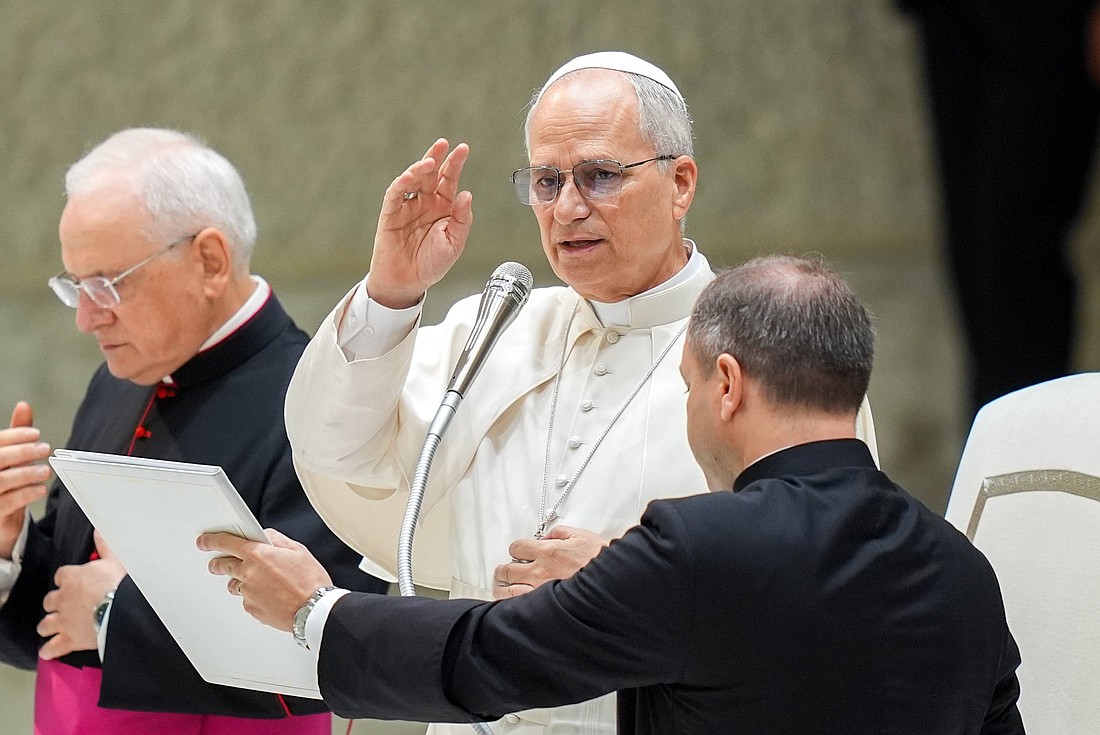 Pope Leo XIV gives his blessing to visitors and pilgrims at the conclusion of his weekly general audience in the Paul VI Audience Hall at the Vatican Aug. 27, 2025. (CNS photo/Lola Gomez)