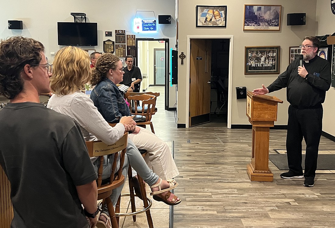 Father Michael Kennedy, pastor of St. Luke Parish, Toms River, speaks to young adults on the topic, "The World Is Not What We Think" during an Aug. 26 Theology on Tap held in Jackson. Elizabeth Zimak photos