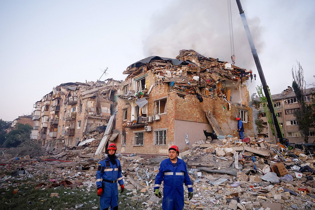 Rescuers stand at the site of a building which was hit by Russian missile and drone strikes in Kyiv, Aug. 28, 2025. (OSV News photo/Valentyn Ogirenko, Reuters)
