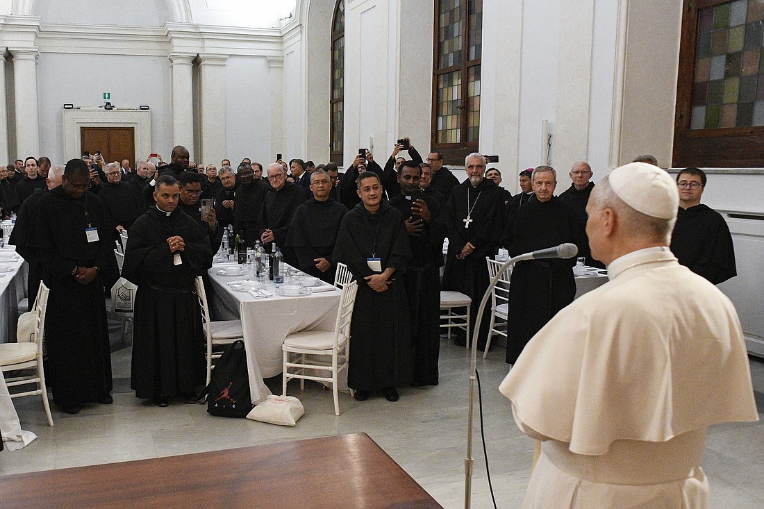 Pope Leo XIV blesses his Augustinian confreres and their meal as he joins them for dinner Sept. 1, 2025, in a hall of the Italian attorney general's office next to the Basilica of St. Augustine in Rome. (CNS photo/Vatican Media)