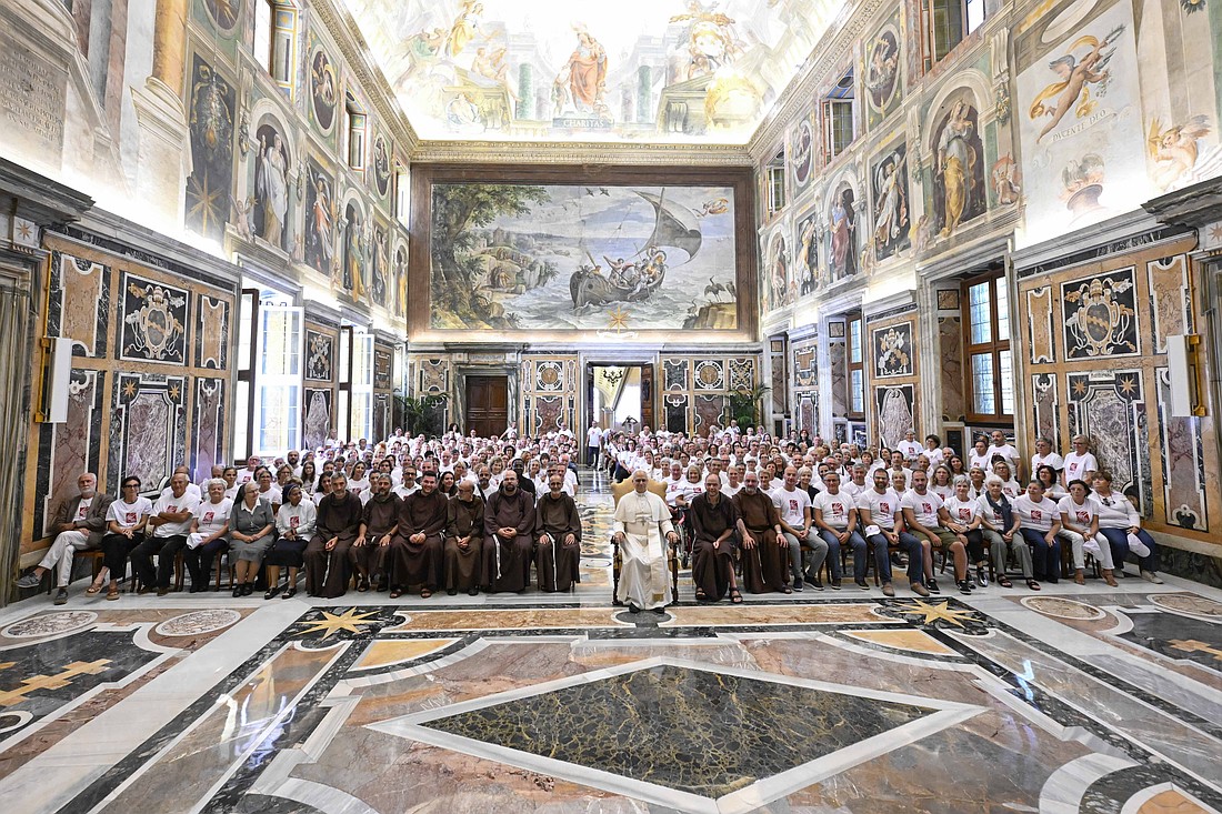 Pope Leo XIV poses for a photo with Capuchin friars and other people involved in the Milan-based charity, Opera San Francesco for the Poor, during an audience at the Vatican Sept. 1, 2025. Standing next to him is Msgr. Leonardo Sapienza, regent of the Prefecture of the Papal Household. (CNS photo/Vatican Media)