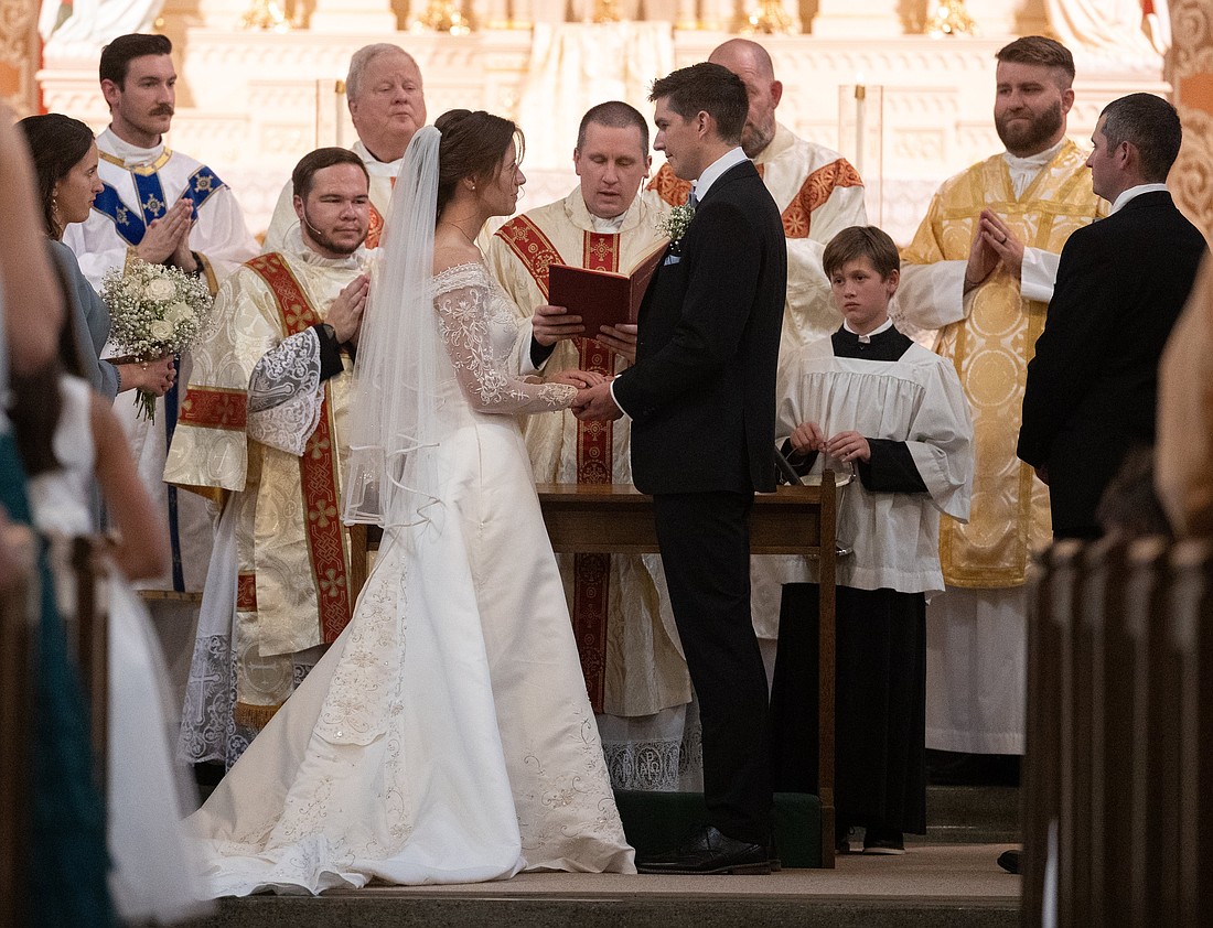 An altar server looks on as a couple exchange wedding vows at St. Mary Church in Chatfield, Minn., Sept. 14, 2024. (OSV News photo/Dave Hrbacek, The Catholic Spirit)