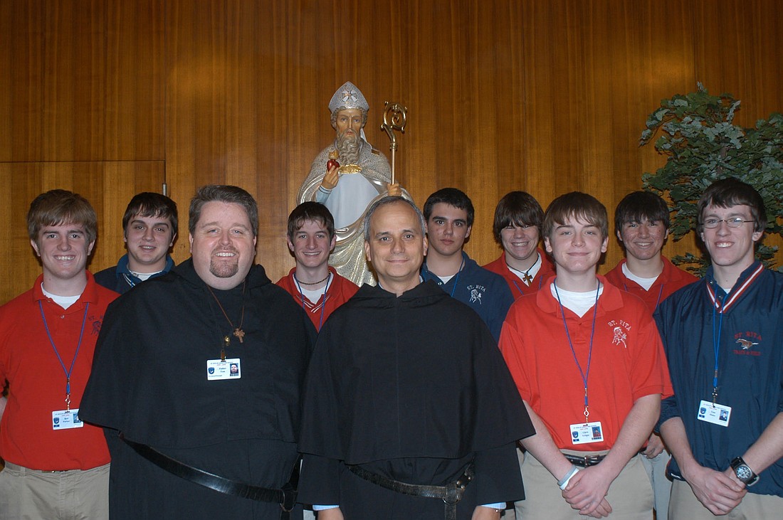 Then-Father Robert F. Prevost, now Pope Leo XIV,  front center, prior general of the Augustinian order, poses with Augustinian Father Tom McCarty, president of St. Rita High School in Chicago, and upperclassmen in January 2006. (OSV News photo/courtesy The Beverly Review).