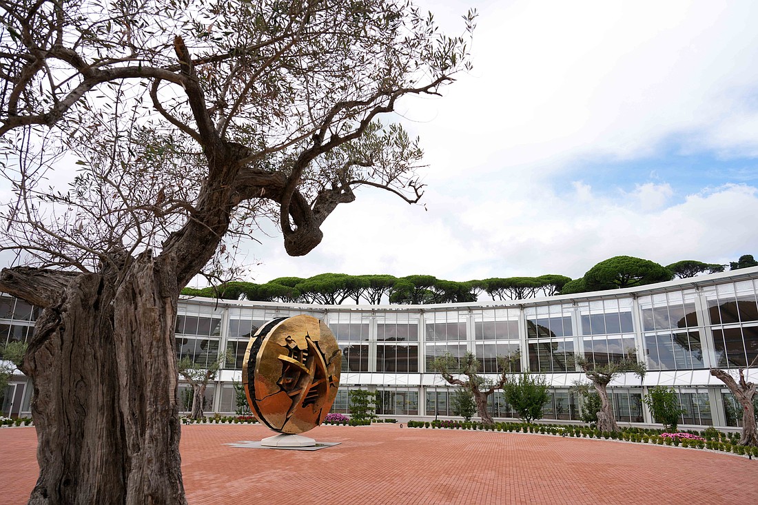 A bronze sculpture titled "Disk in the Form of a Desert Rose" by Italian artist Arnaldo Pomodoro stands at the center of the Borgo Laudato Si’ greenhouse in Castel Gandolfo, Italy, Sept. 2, 2025.  Pope Leo XIV is scheduled to inaugurate the site Sept. 5, 2025, which includes gardens, farmland, historic villas and educational spaces dedicated to being a model where the care of creation and the defense of human dignity are taught and lived, and are open to all. (CNS photo/Lola Gomez)