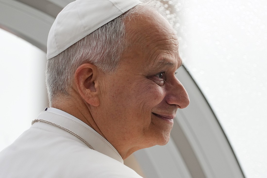 Pope Leo XIV smiles as he greets visitors and pilgrims from the popemobile under the rain in St. Peter’s Square at the Vatican before his weekly general audience Sept. 10, 2025. (CNS photo/Lola Gomez)
