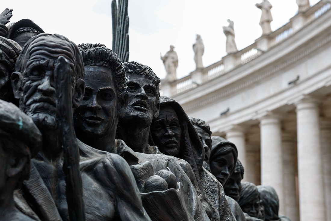 A detail is seen of "Angels Unawares," a sculpture by Canadian Timothy Schmalz in St. Peter's Square at the Vatican, June 3, 2024. The sculpture depicts a boat with 140 figures of migrants from various historical periods and various nations. (CNS photo/Lola Gomez)