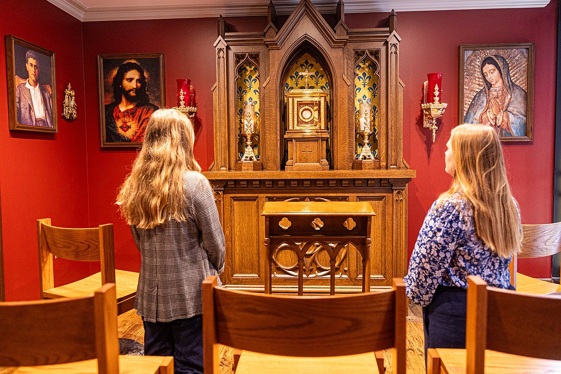 Two women pray at the new St. Pier Giorgio Frassati Chapel located next to the office of Immaculate Conception Parish in Washington Aug. 22, 2025. The new chapel is named for the new saint who was canonized by Pope Leo XIV on Sept. 7, 2025. St. Pier Giorgio, an Italian young adult who died in 1925, was known for his devotion to the Eucharist and service to those in need. (OSV News photo/Mihoko Owada, Catholic Standard)