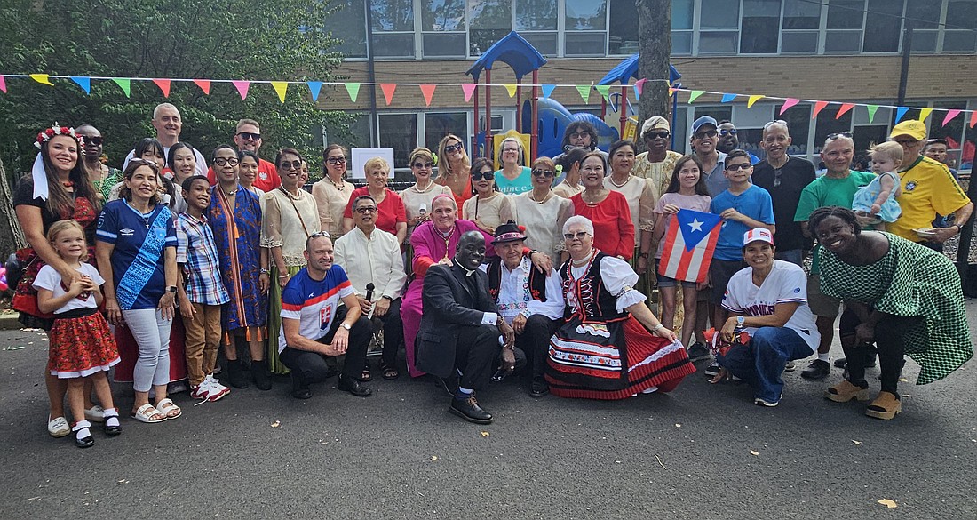 Bishop O'Connell is surrounded by members of St. Ann Parish, Lawrenceville, during the Multicultural Parish Picnic held Sept. 14 on the school grounds.