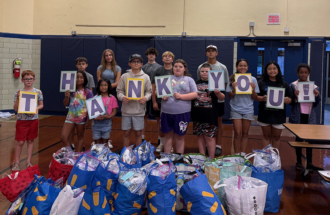 In Sacred Heart Parish, Mount Holly, the “Mini Vinnies” and “Young Vincentians” recently held a blessing bag event to assist people in need.  Here, religious education students from third grade through high school help to package bags with their families. Courtesy photo