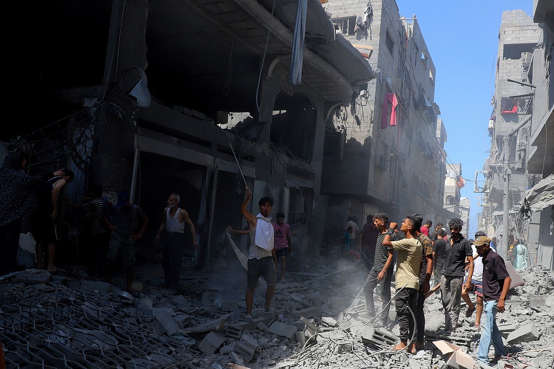 Palestinians gather amid rubble after an Israeli missile strike hit an evacuated residential building at Shati (Beach) refugee camp in Gaza City Sept. 11, 2025. (OS News photo/Ebrahim Hajjaj, Reuters)