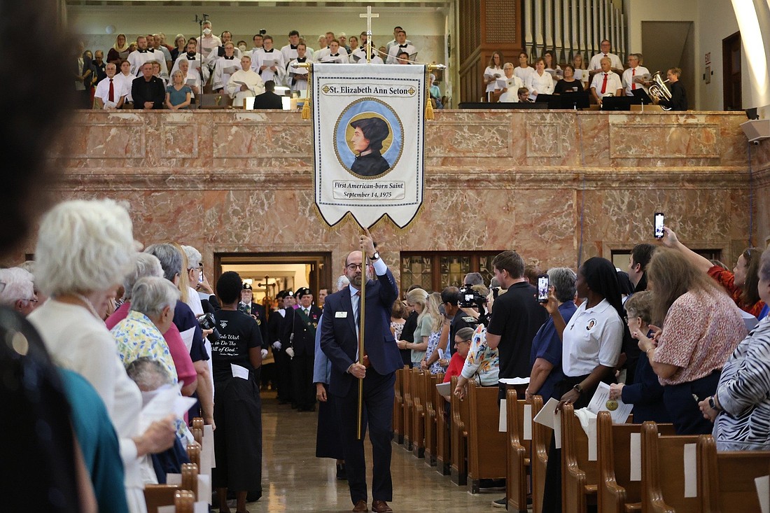 A man carries a banner of St. Elizabeth Ann Seton during a Mass to celebrate the 50th anniversary of her 1975 canonization at the national shrine in her name in Emmitsburg, Md., Sept. 14, 2025. (OSV News photo/courtesy Seton Shrine)