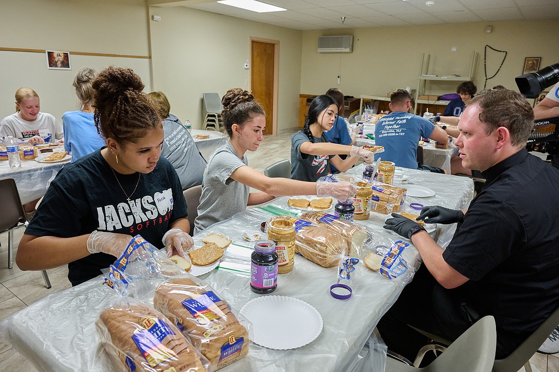 Seminarian Kyle Holler, right, was on hand to help with the July 8 Mission: Jersey Seeds of Service gathering in Brick. Here he helps young people with making peanut butter and jelly sandwiches. Mike Ehrmann photo