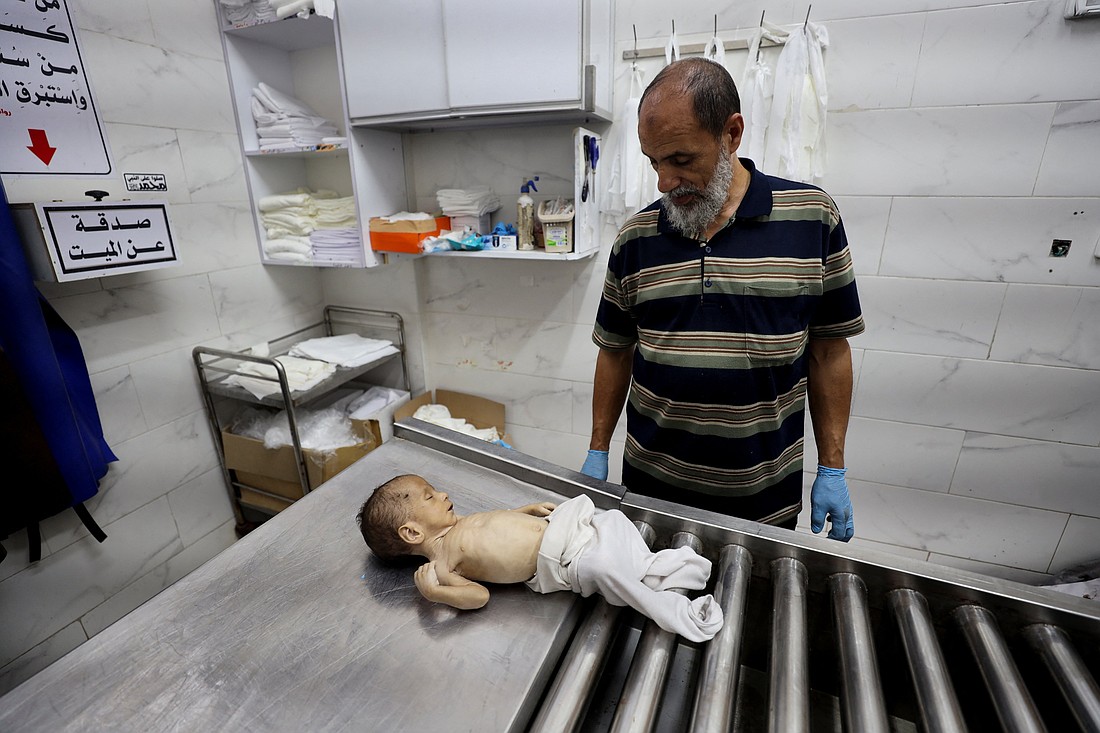 A man stands next to the body of 6-week-old infant Yousef al-Safadi at Shifa hospital in Gaza City July 22, 2025, who died of starvation, according to health officials. A United Nations-affiliated organization that tracks food security worldwide has issued a dire alert confirming that a "worst-case" famine scenario is unfolding across the Gaza Strip. (OSV News photo/Khamis Al-Rifi , Reuters) Editors: SENSITIVE MATERIAL. THIS IMAGE MAY OFFEND OR DISTURB