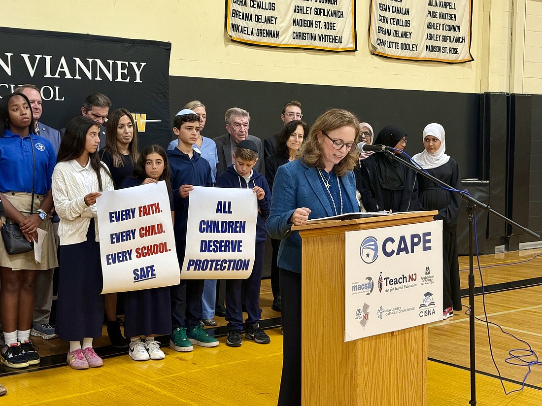 Bonnie Milecki, assistant superintendent of Catholic schools in the Diocese of Trenton and president of the New Jersey Council for American Private Education, addresses students and community leaders Sept. 18 during a school security and solidarity event in St. John Vianney High School, Holmdel. The gathering, hosted by NJCAPE and Teach NJ, united Catholic, Jewish, Christian and Islamic schools with lawmakers in calling for stronger protections for non-public school students.