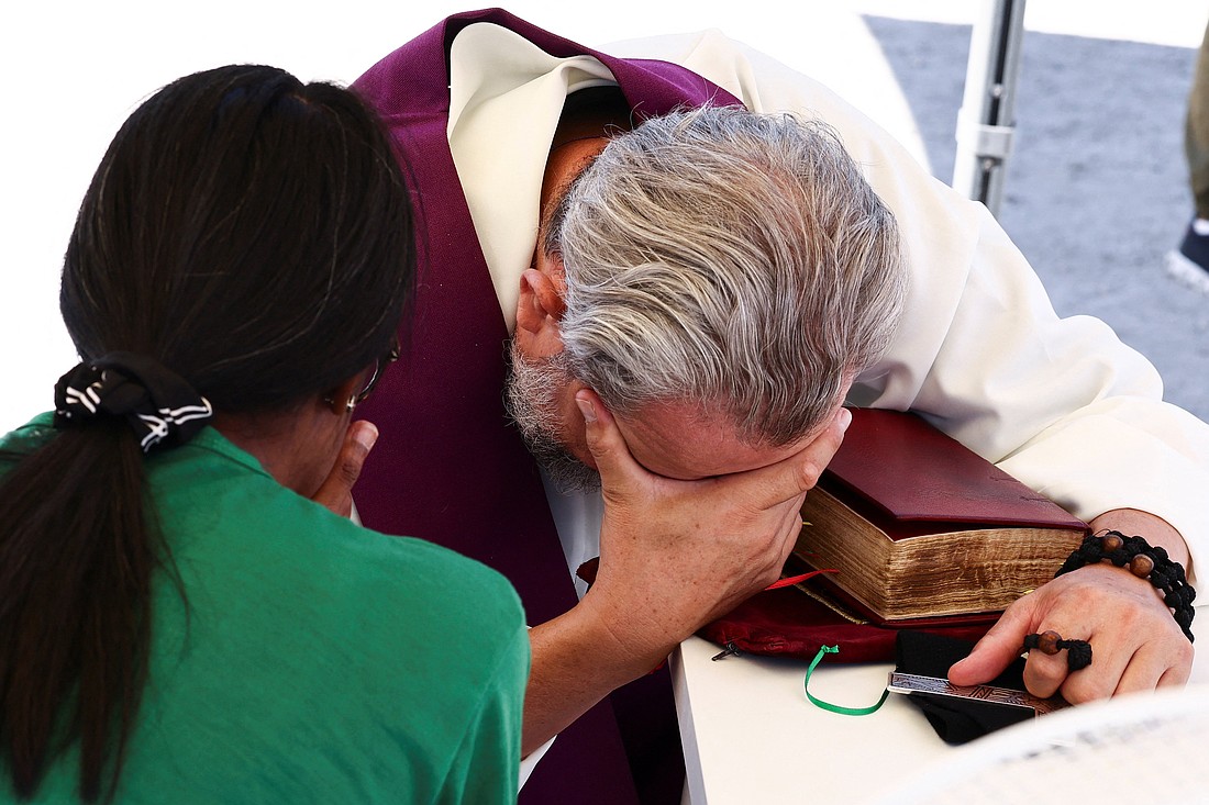 A priest reacts hears confession from a young woman at  Circus Maximus in Rome July 31, 2025, during the Jubilee of Youth. For his Gospel reflection Father Garry Koch speaks of finding God's mercy and the forgiveness of sins. (OSV News photo/Remo Casilli, Reuters)
