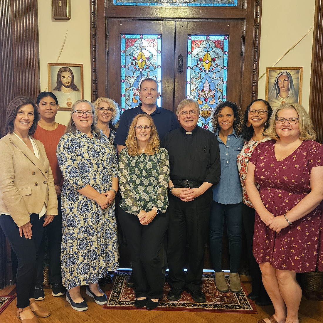 Father John Czahur, pastor of Sacred Heart Parish, Mount Holly, is joined by his parish catechetical leader, Barb Kane, and catechists from the parish during a Catechetical Sunday celebration Sept. 21. At far left is Denise Contino, director of the Diocesan Department of Catechesis, who attended the 11:30 a.m. Mass and presented a special award to Kane. Mary Stadnyk photo