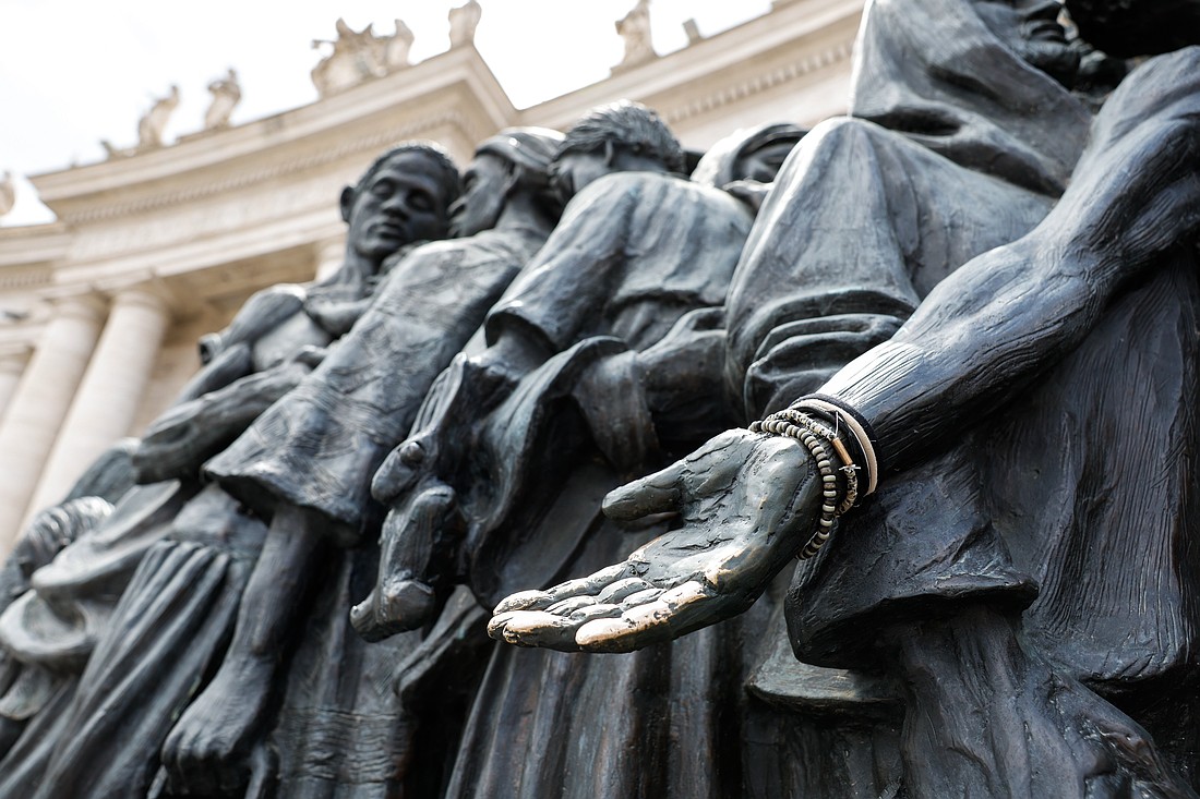 A detail is seen of "Angels Unawares," a sculpture by Canadian Timothy Schmalz in St. Peter's Square at the Vatican, June 3, 2024. The sculpture depicts a boat with 140 figures of migrants from various historical periods and various nations. (CNS photo/Lola Gomez)