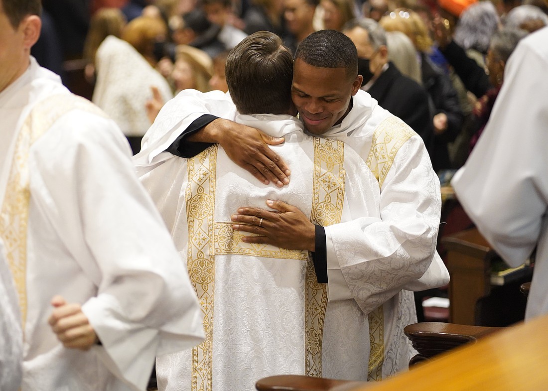 Callistus Ibeh, right, exchanges the sign of peace with fellow Diocese of Brooklyn, N.Y., seminarian Juan Herrera-Posada  during their ordination to the transitional diaconate at St. Joseph's Seminary in Yonkers, N.Y., Nov. 9, 2024. Eight seminarians completing their preparation for the priesthood were ordained at the Mass: five for the Diocese of Brooklyn and three for Archdiocese of New York. The liturgy was celebrated on the final day of National Vocations Awareness Week. (OSV News photo/Gregory A. Shemitz)