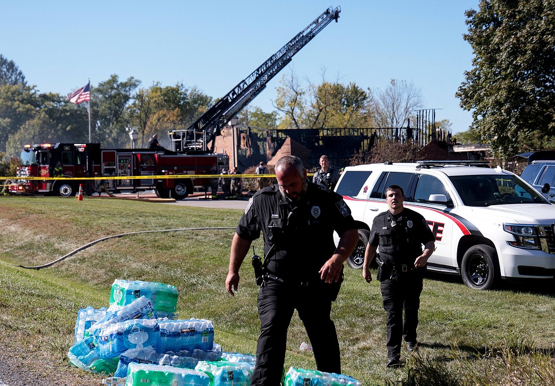 Law enforcement officers work near the burnt Church of Jesus Christ of Latter-day Saints, after a mass shooting and a fire took place, in Grand Blanc, Mich., Sept. 28, 2025. (OSV News photo/Rebecca Cook, Reuters)