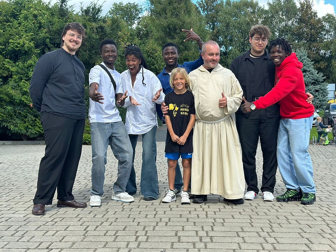 Polish Capuchin Father Benedykt Paczka is seen with students of his African Music School and volunteers in Belachtow, Poland, on an undated photograph. The Central African Republic, where the school was established, is one of the poorest and most unstable countries in the world. For years, it has been ravaged by civil war, tribal conflicts, and a lack of prospects for young people. A Capuchin-run music school, where they can learn to sing and play instruments, changes lives of local youth. (OSV News photo/courtesy Father Benedykt Paczka)
