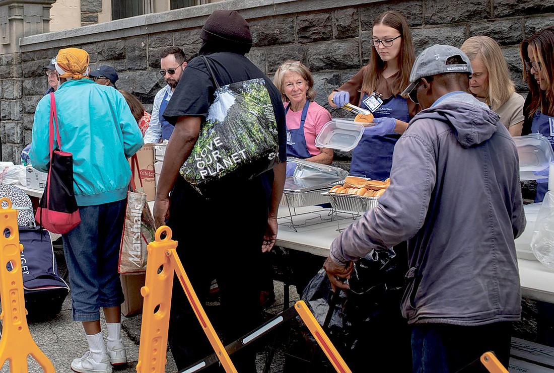 Volunteers serve meals to guests at Catholic Charities’ St. Maria’s Meals program Aug. 20, 2025. Every Wednesday afternoon outside Catholic Charities headquarters in Washington, the St. Maria’s Meals program serves hot and nutritious meals to people experiencing homelessness or food insecurity. Catholic Charities of the Archdiocese of Washington has expanded its homeless shelter capacity in the District of Columbia as homeless encampments are being removed across the nation’s capital. (OSV News photo/courtesy of Catholic Charities)