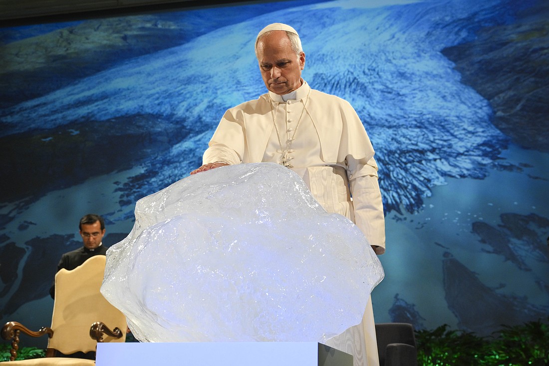 Pope Leo XIV blesses a chunk of ice from a glacier in Greenland during the opening session of an international conference celebrating the 10th anniversary of Pope Francis' encyclical "Laudato Si', on Care for Our Common Home," at the Mariapolis Center in Castel Gandolfo, Italy, Oct. 1, 2025. The ice block was fished out of the Nuup Kangerlua fjord in Greenland after becoming detached from the ice sheet. It was brought to the event by artist Olafur Eliasson with the help of geologist Minik Rosing. (CNS photo/Vatican Media)