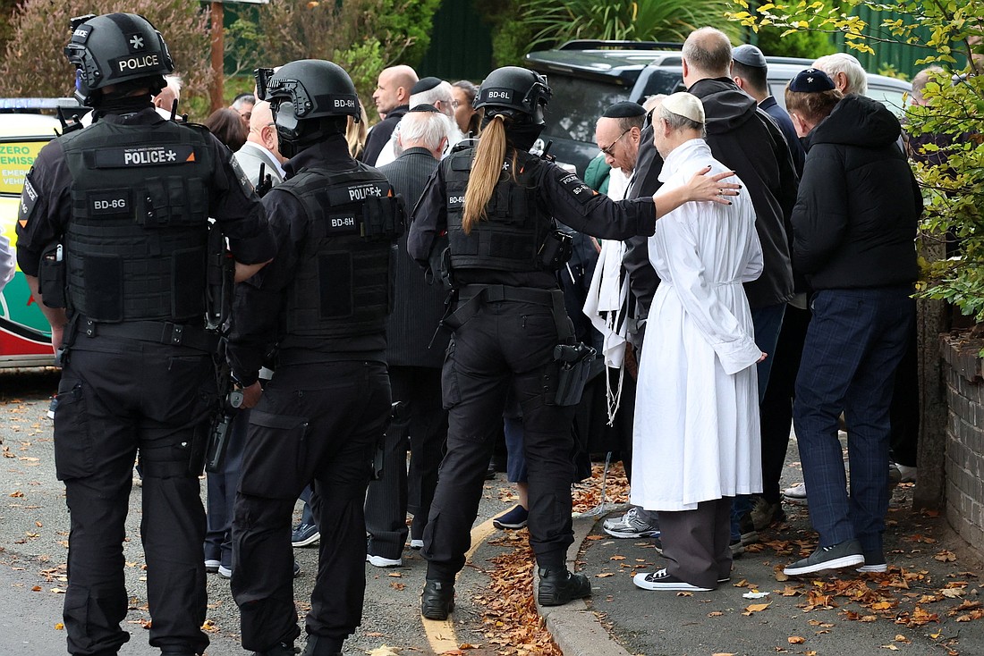 Police and others gather near the scene after a report of an incident in which a car was driven at pedestrians and a stabbing attack, near a synagogue in north Manchester, England, Oct. 2, 2025. A man attacked a synagogue killing at least two people and seriously injuring others in what the police called an act of terrorism on Yom Kippur, the holiest day in the Jewish calendar. (OSV News photo/Phil Noble, Reuters)