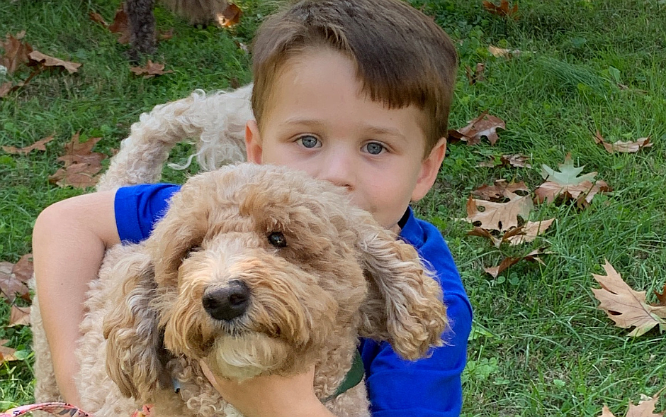 A young parishioner from Our Lady of Perpetual Help Parish, Maple Shade, holds his dog during the Oct. 5 blessing of animals in honor of St. Francis of Assisi. Facebook photo