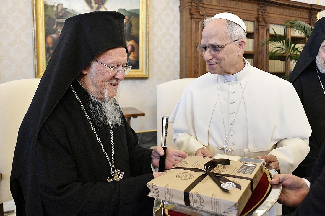 Pope Leo XIV receives a gift from Orthodox Ecumenical Patriarch Bartholomew of Constantinople during a meeting in the library of the Apostolic Palace at the Vatican May 30, 2025. The Vatican provided no details about the meeting, which was the second private encounter between the two since the pope's inaugural Mass May 18. (CNS photo/Vatican Media)