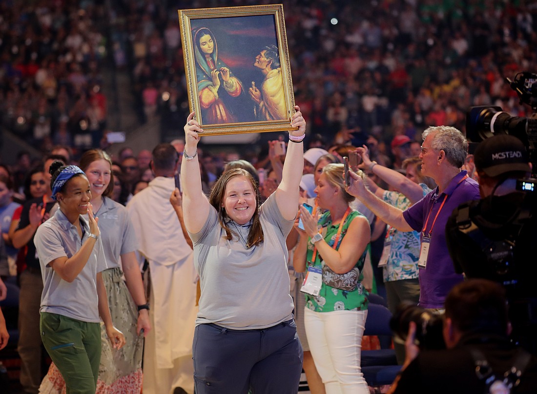 Perpetual pilgrim MacKenzie Warrens with the Juan Diego Route processes in with other members of the group during the opening revival night of the National Eucharistic Congress at Lucas Oil Stadium in Indianapolis July 17, 2024. (OSV News photo/Bob Roller)