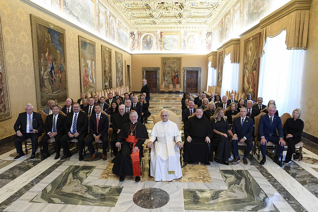 Pope Leo XIV poses for a photo after an audience at the Vatican Oct. 9, 2025, with labor union leaders from Chicago making a Jubilee pilgrimage to Rome. Chicago Cardinal Blase J. Cupich is seated next to the pope. (CNS photo/Vatican Media)