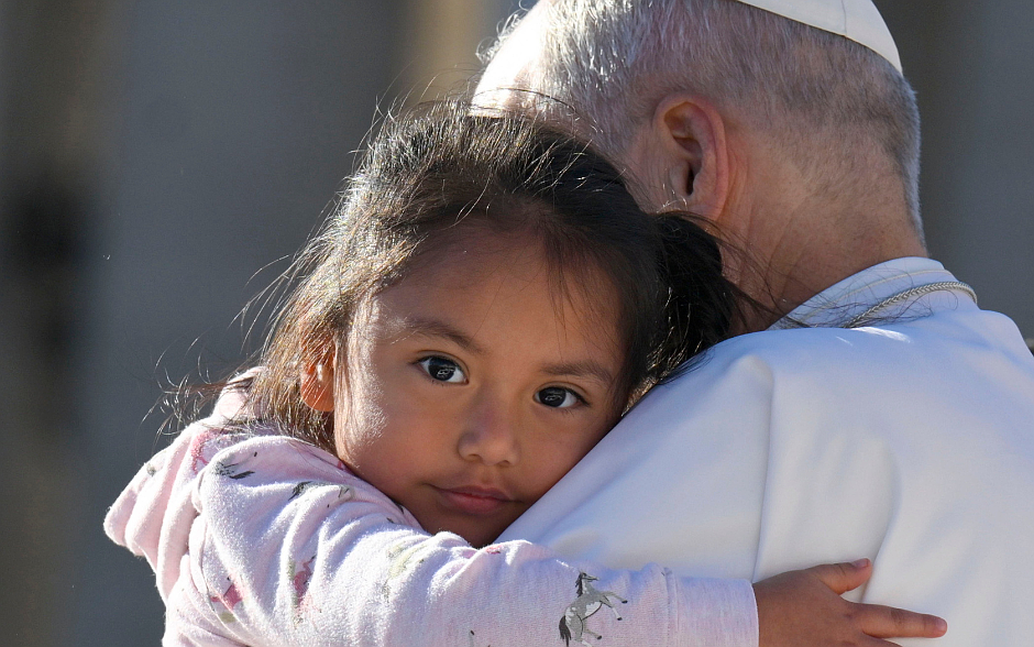 Pope Leo XIV embraces a child in his popemobile during his weekly general audience in St. Peter's Square at the Vatican Oct. 8, 2025. OSV News photo/Simone Risoluti, Vatican Media