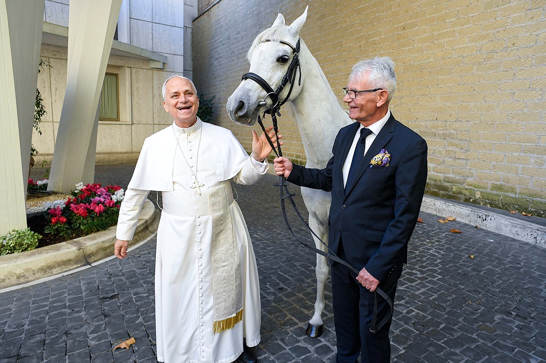 Pope Leo XIV smiles as he receives a purebred Arabian horse donated by a Polish horse breeder at the Vatican Oct. 15, 2025. The pope often traveled by horse when serving as a missionary in Peru. (CNS photo/Vatican Media)