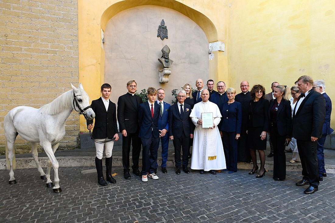 Pope Leo XIV poses for a photo as he receives a purebred Arabian horse donated by a Polish horse breeder at the Vatican Oct. 15, 2025. The pope often traveled by horse when serving as a missionary in Peru. (CNS photo/Vatican Media)