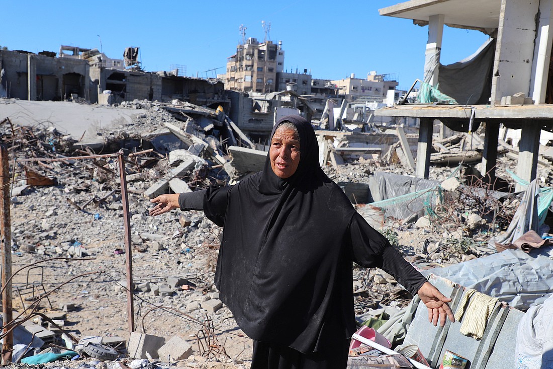 A Palestinian woman walks on the rubble of her destroyed home in Gaza City Oct. 15, 2025, after a ceasefire between Israel and Hamas in Gaza went into effect. She now lives in a tent after getting displaced during the war. (OSV News photo/Ebrahim Hajjaj, Reuters)