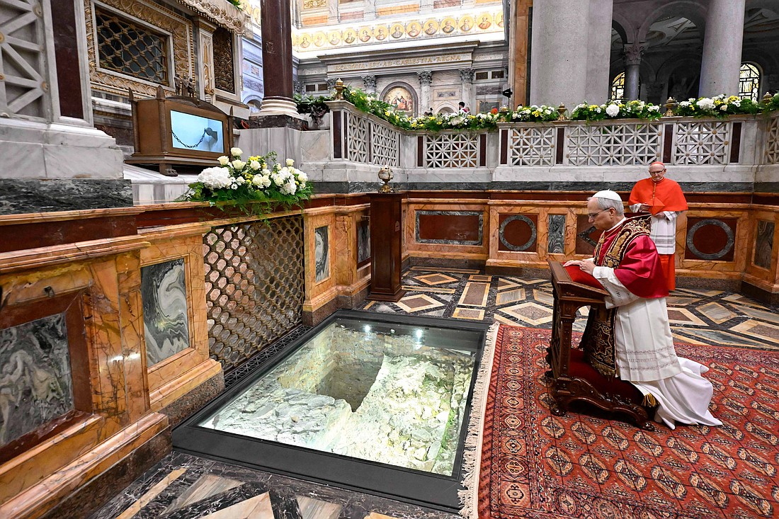 Pope Leo XIV prays at the tomb of the Apostle Paul in Rome's Basilica of St. Paul Outside the Walls in this file photo from May 20, 2025. Britain's King Charles III is expected to pray at the tomb before an ecumenical prayer service Oct. 23. (CNS photo/Vatican Media)