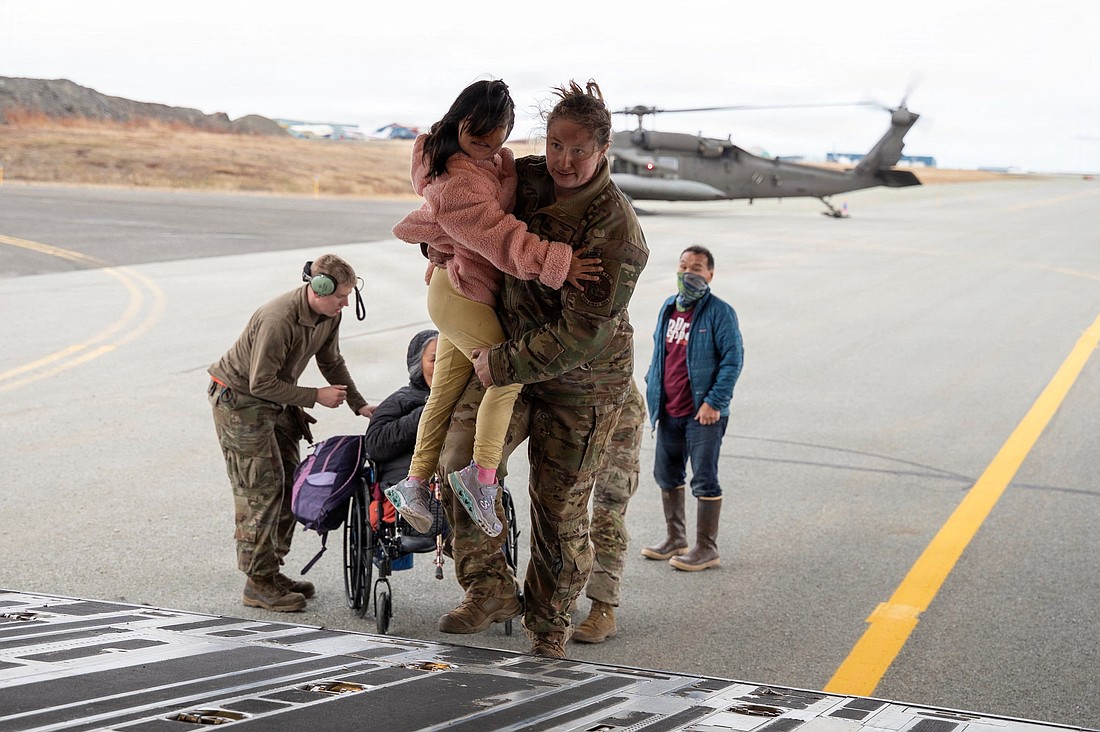 Alaska Air National Guard Tech. Sgt. Annie Kilborn assists a child as Alaska Army National Guard evacuates people out of Bethel, following the devastating Typhoon Halong, in Alaska, Oct. 15, 2025. (OSV News photoJoseph Moon, Alaska National Guard handout via Reuters)  Editors: THIS IMAGE HAS BEEN SUPPLIED BY A THIRD PARTY. NO RESALES. NO ARCHIVES. MANDATORY CREDIT..